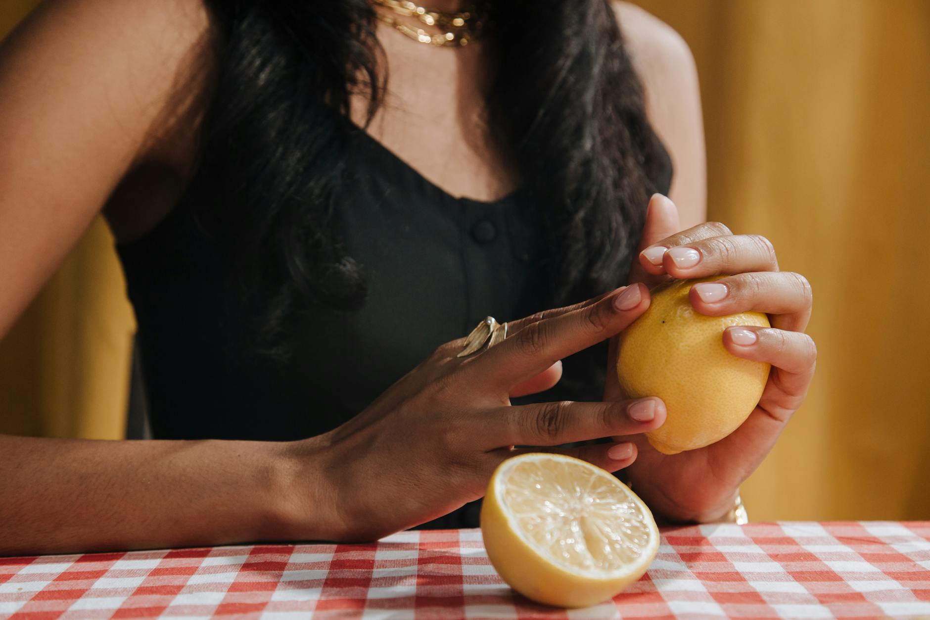 Hand holding a vibrator against a minimalistic purple backdrop, showing modern self-care approach