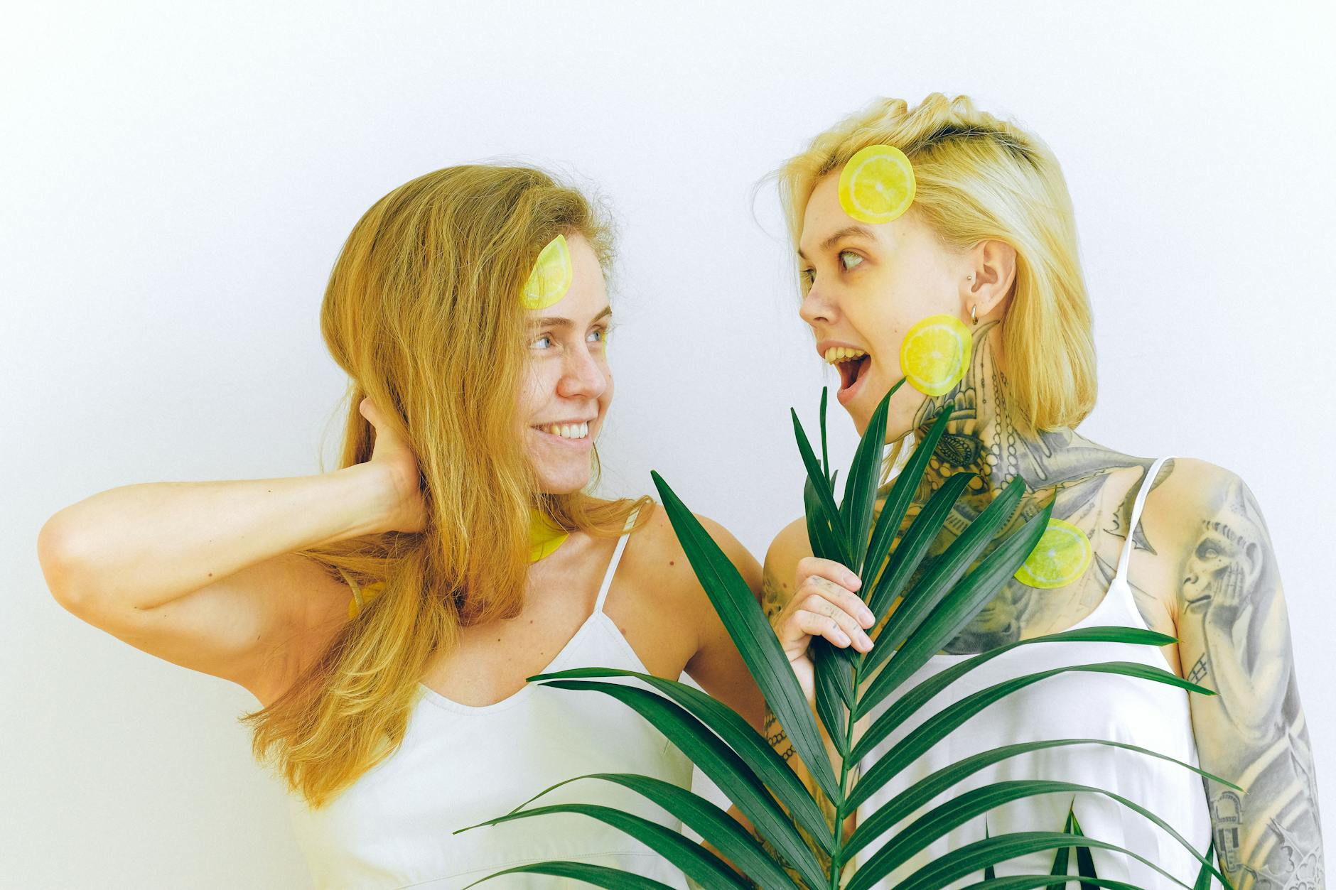Two women smiling and laughing together indoors, expressing joy and comfort.