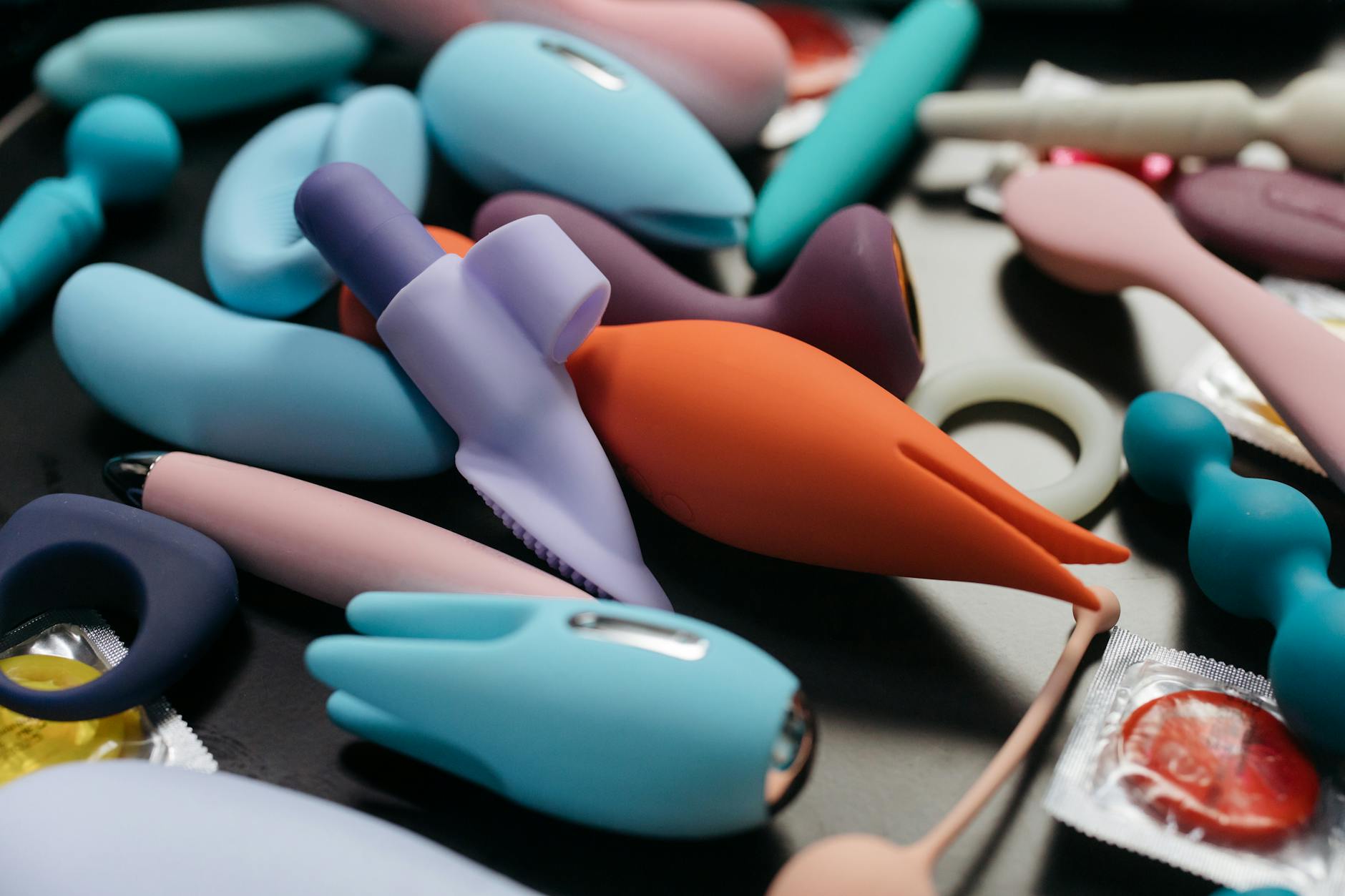 An array of vibrant lemon clitoral vibrators displayed together, showing different shapes and colors.