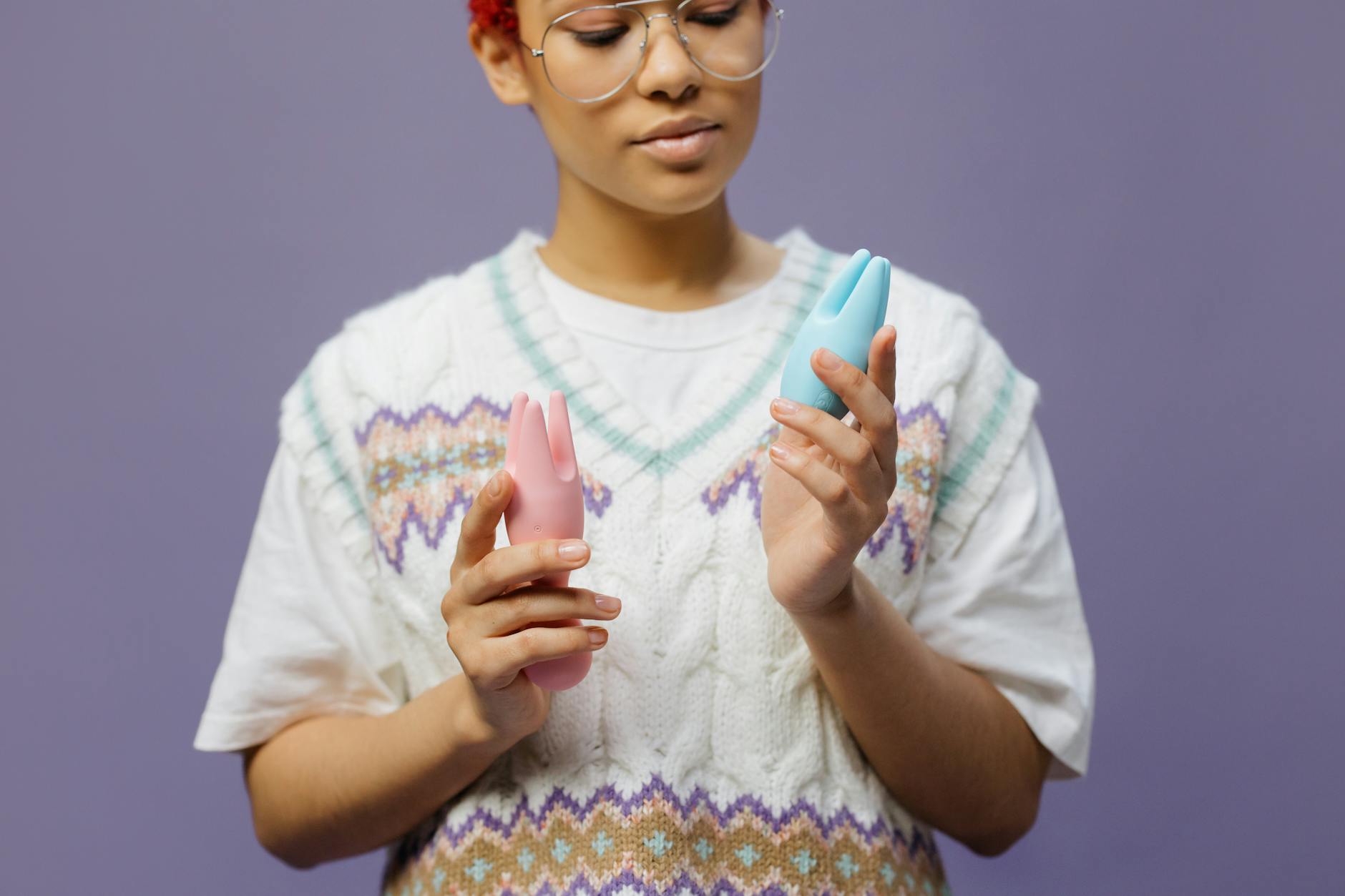 Woman holding a blue silicone vibrator, representing shared pleasure and intimacy with a partner