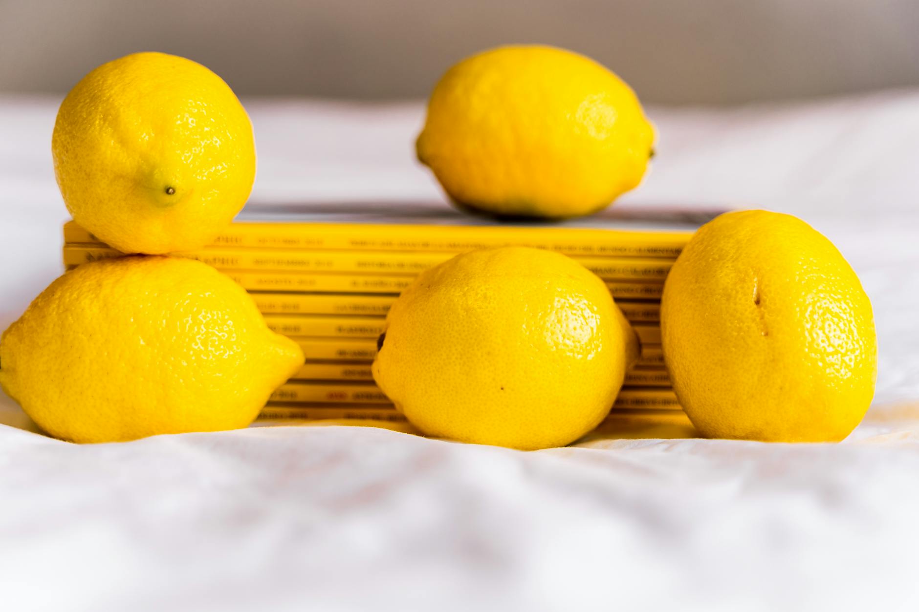 Fresh lemons arranged with stacked books, symbolizing clarity and natural pleasure.